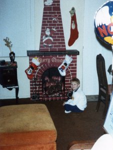 Here's Eric warming himself in front of our faux Christmas fireplace. Eric is sitting in the same area where he first started reading to James by himself.