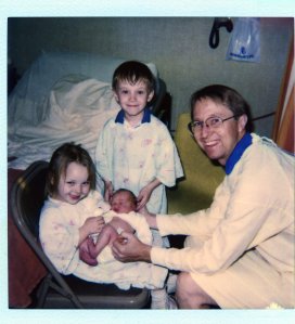 Sheila holding her baby sis Taylor, Eric supporting her head and James.